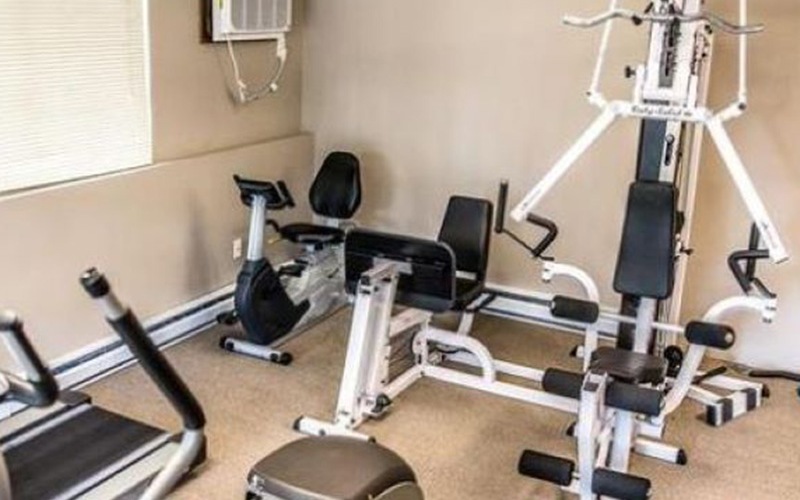 fitness center with large open spaces allowing room for workouts and for using equipment